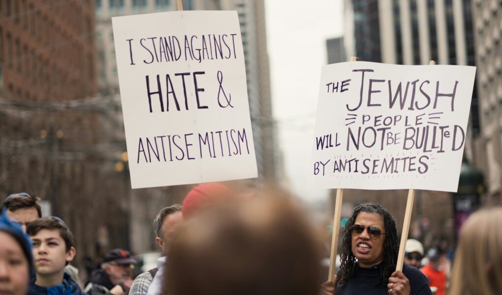 Protest sign reading "Stop Antisemitism" held during a public demonstration, photo by Levi Meir Clancy