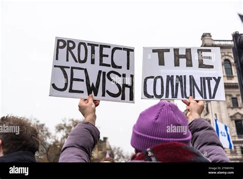 Jewish community members marching with signs to protest rising antisemitism in the U.S.
